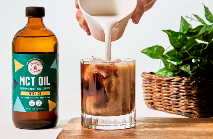 Bottle of MCT oil with cup of keto coffee
